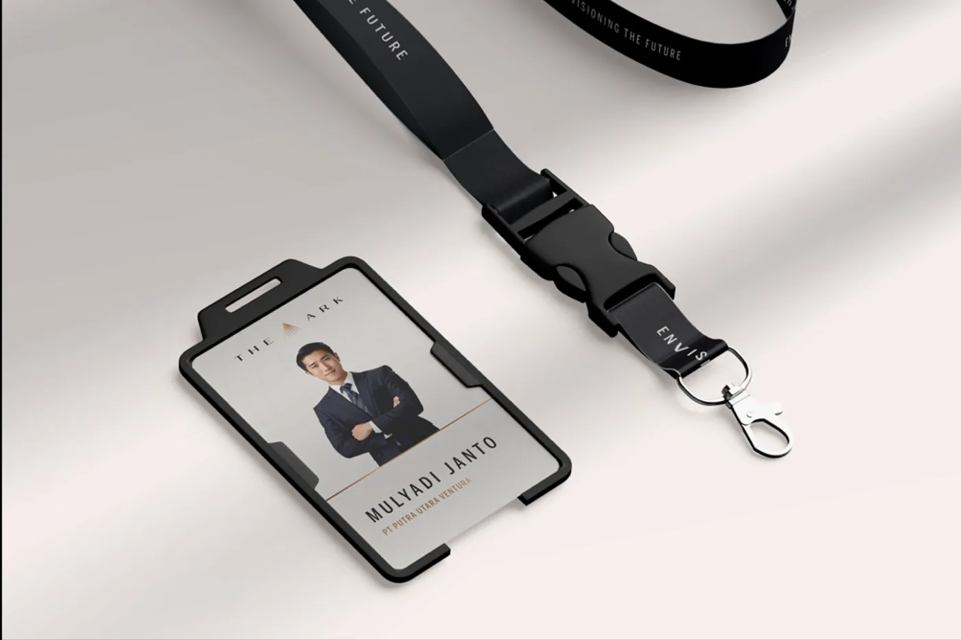 ID badge with a photo of Mulyadi Janto on a black lanyard