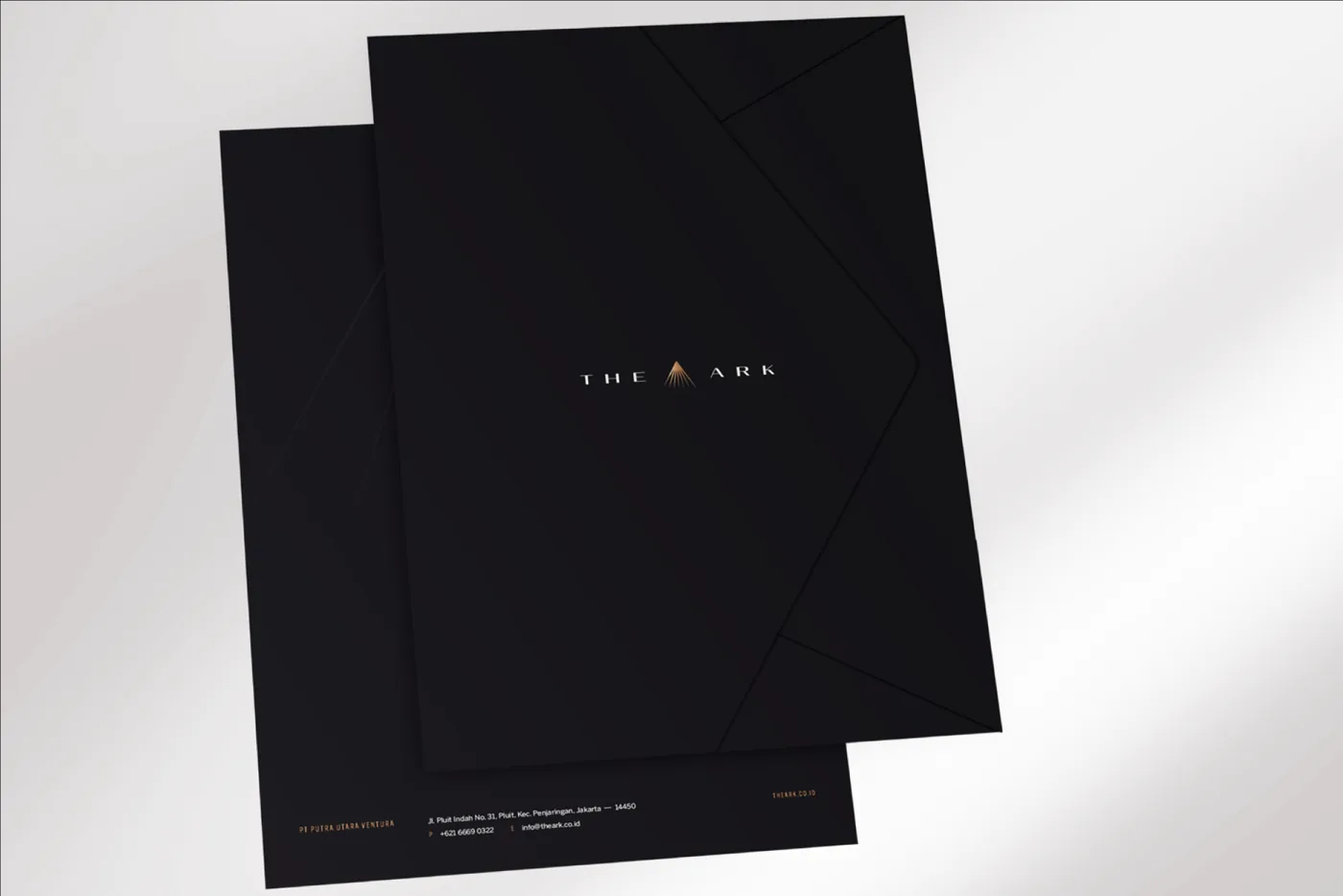 Two black The Ark folders with copper details