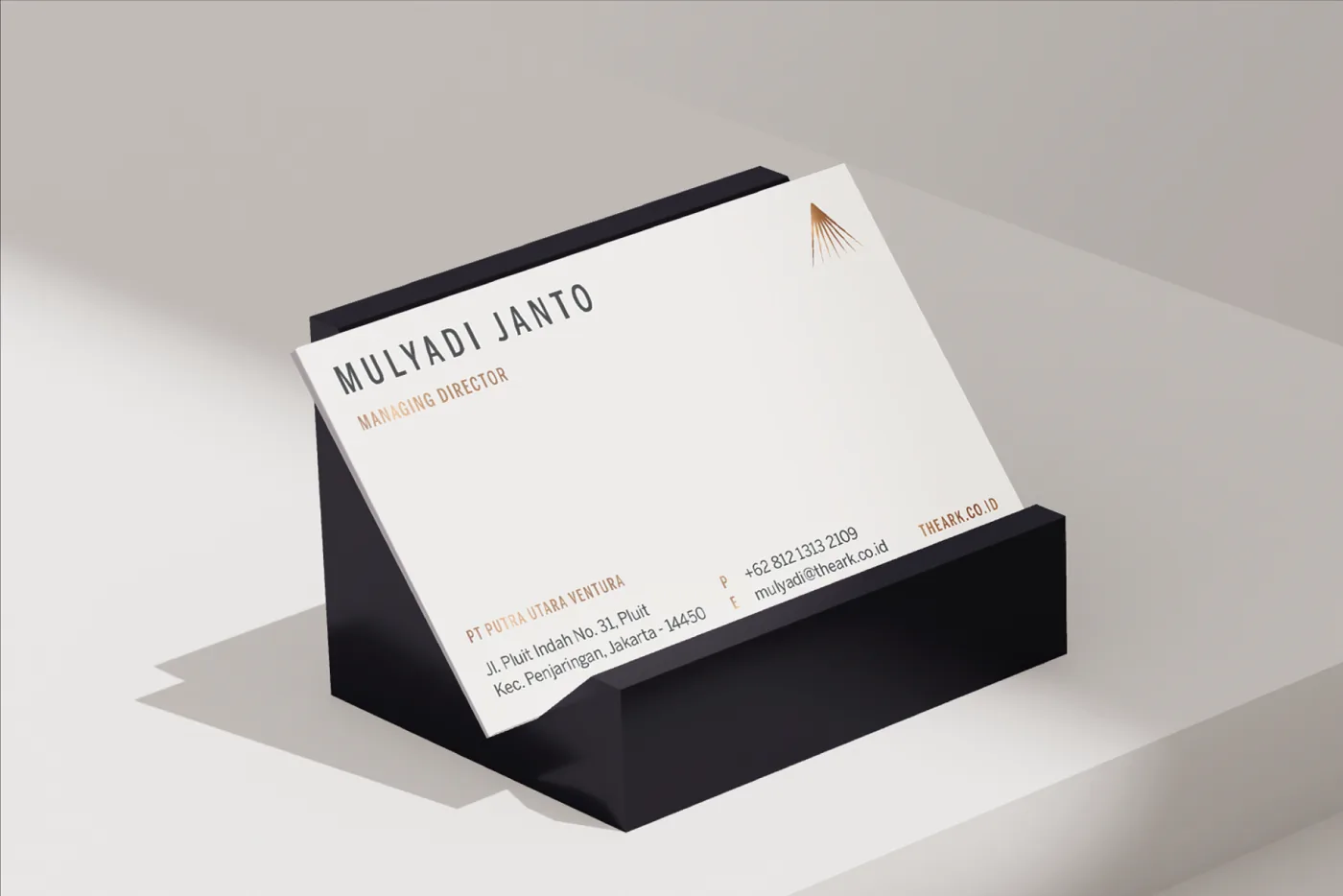 Business card for Mulyadi Janto, Marketing Director, standing in a black holder