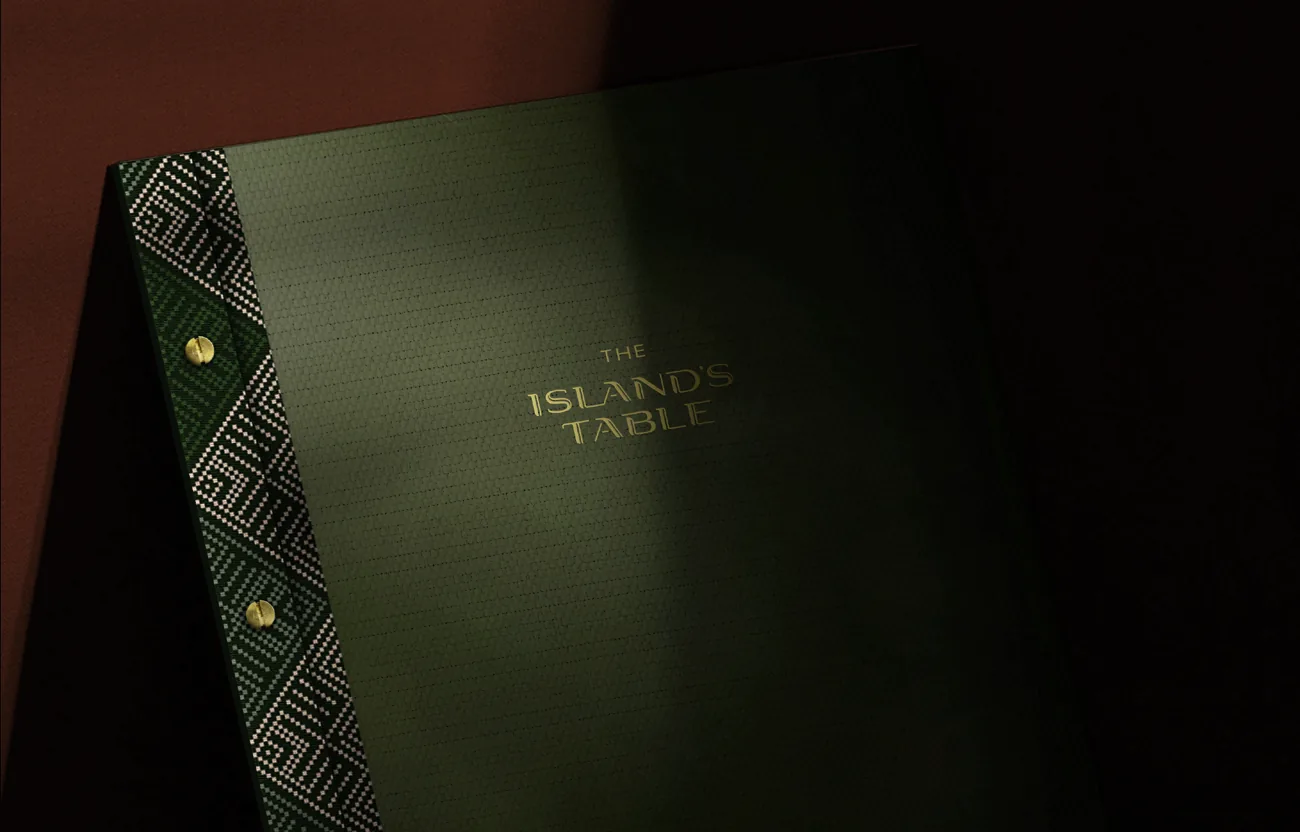 Green woven menu cover with gold wordmark