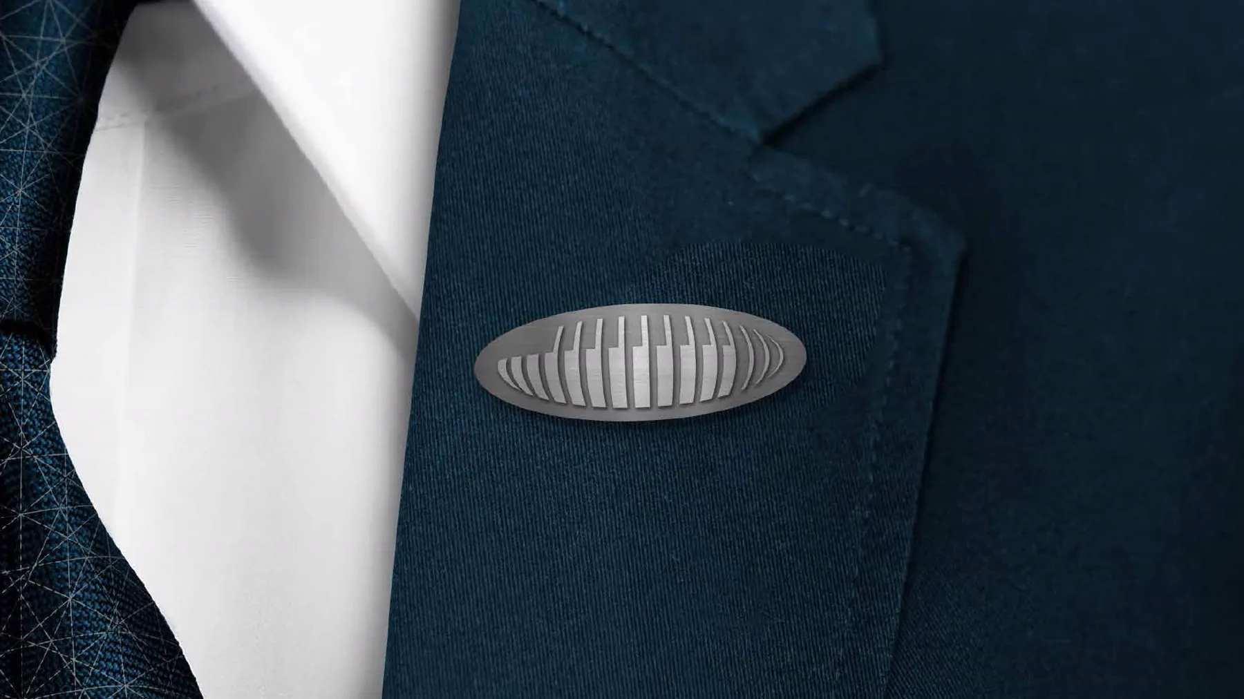 Silver Nords logo pin on a navy suit lapel