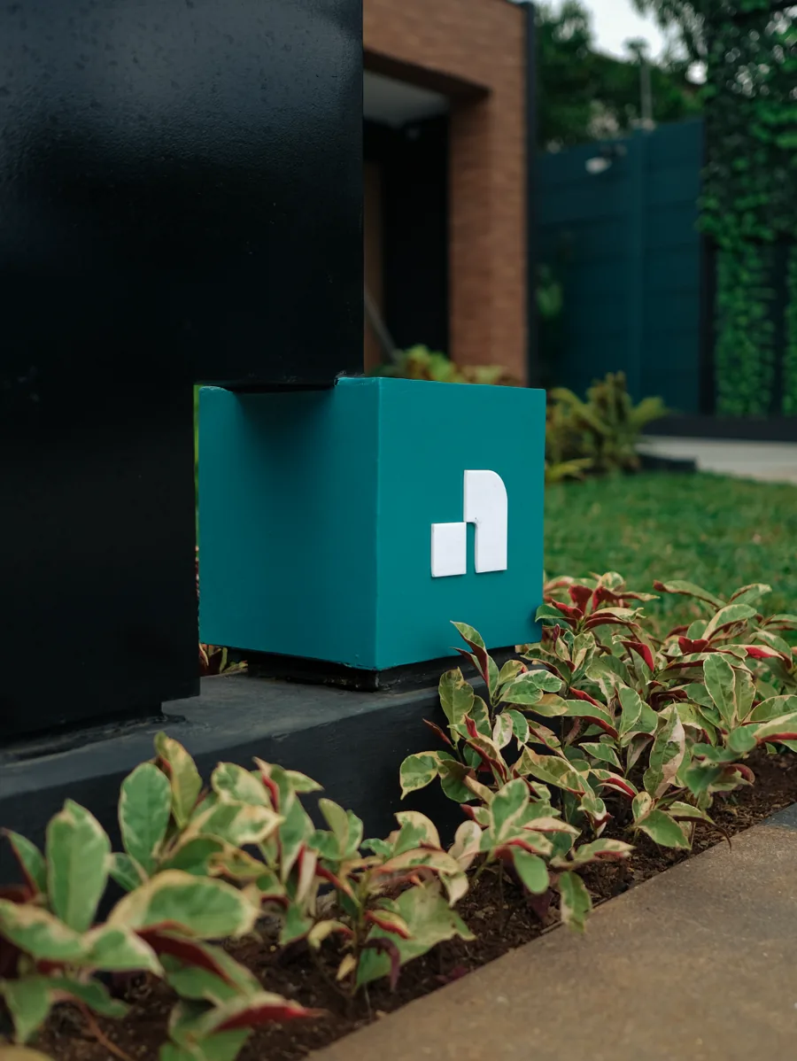 Teal cube marker standing among plants