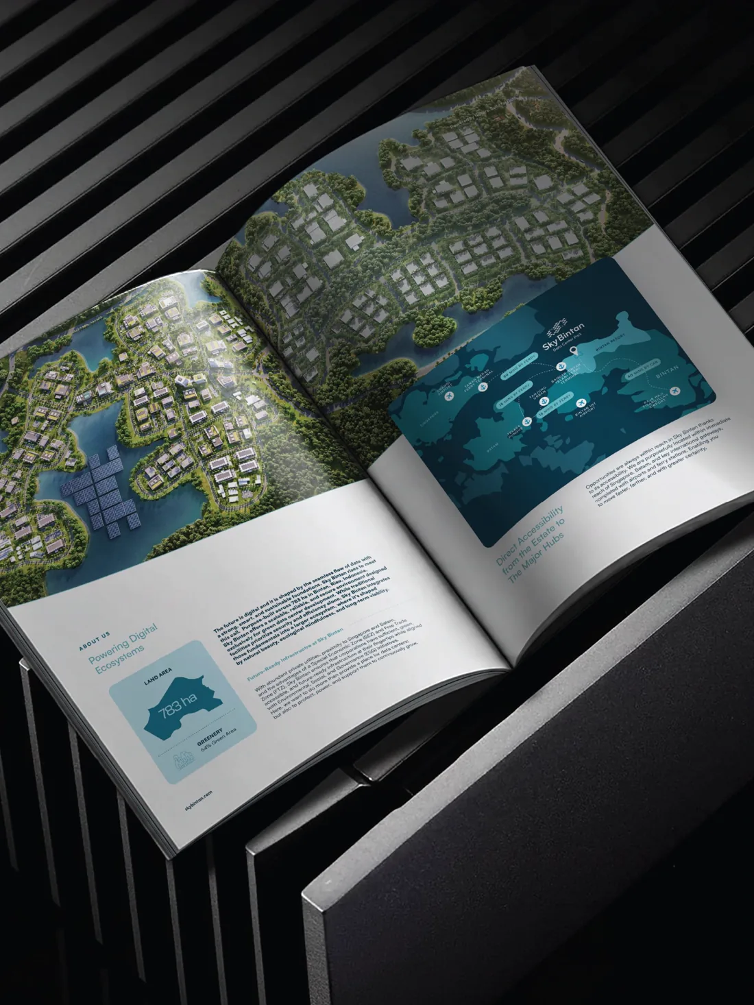 Open company profile spread with an aerial map, on a dark striped surface